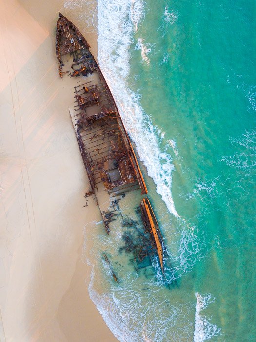 aerial view of a shipwreck on a tropical shore 