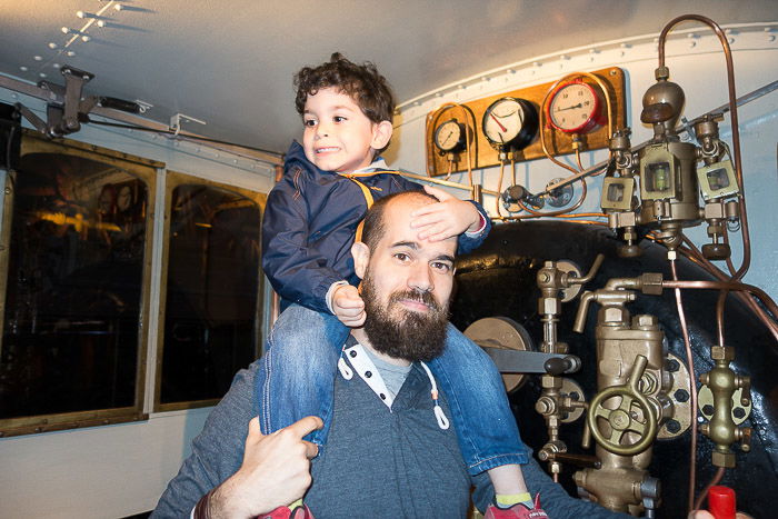 A father and son visiting a train museum