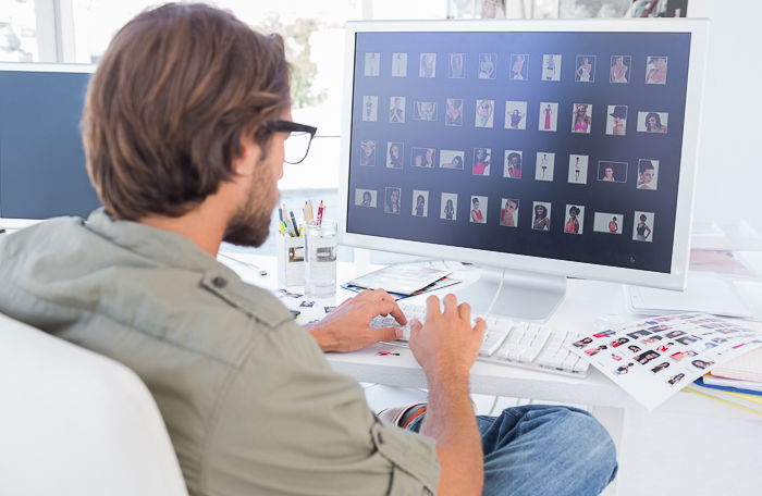 A man editing photos on his laptop