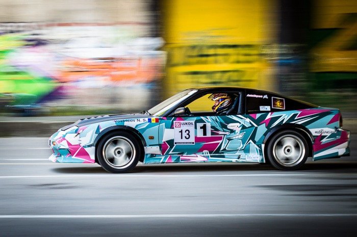 A colorful race car driving with motion blur background 