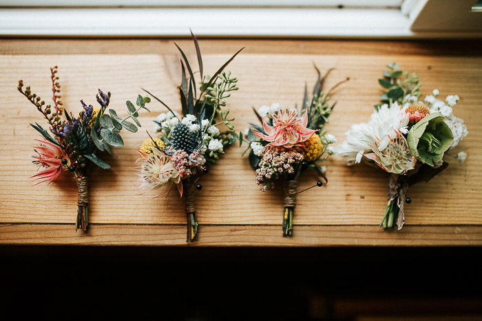 Still life of four wedding flower bouquets on a wooden surface