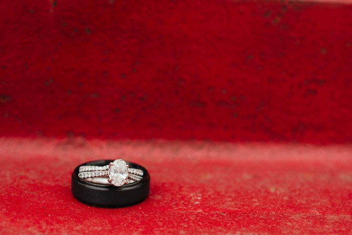 Close up photo of two wedding rings on red background