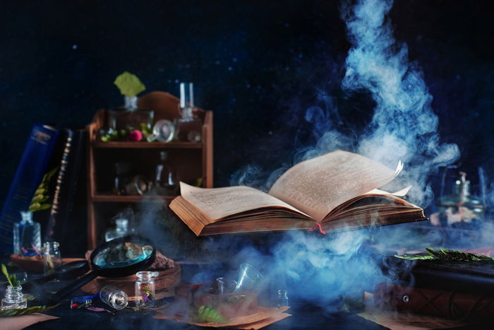 Flying magical book with smoke - still life using colors that contrast with blue