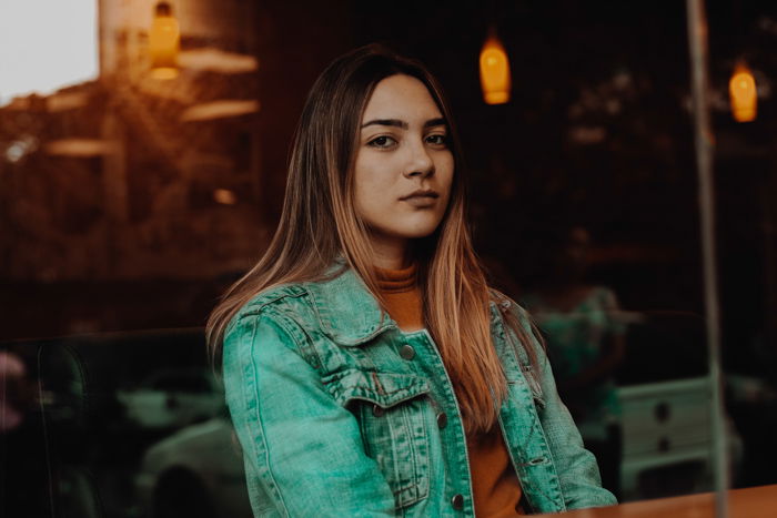 Atmospheric portrait of a female model using orange and blue color in photography