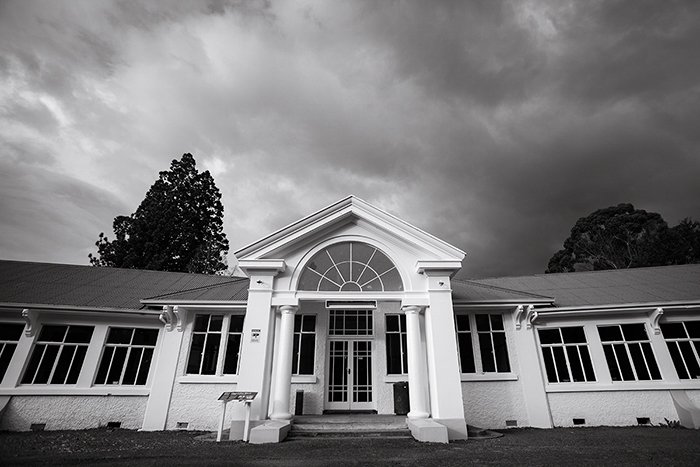 black and white photo of the archway entrance of The Chisholm Ward at Queen Mary Hospital in Hanmer, New Zealand - black and white photo editing