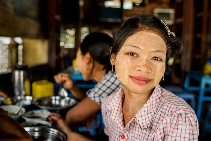 A smiling Karen woman with face-paint - figure to ground photo composition