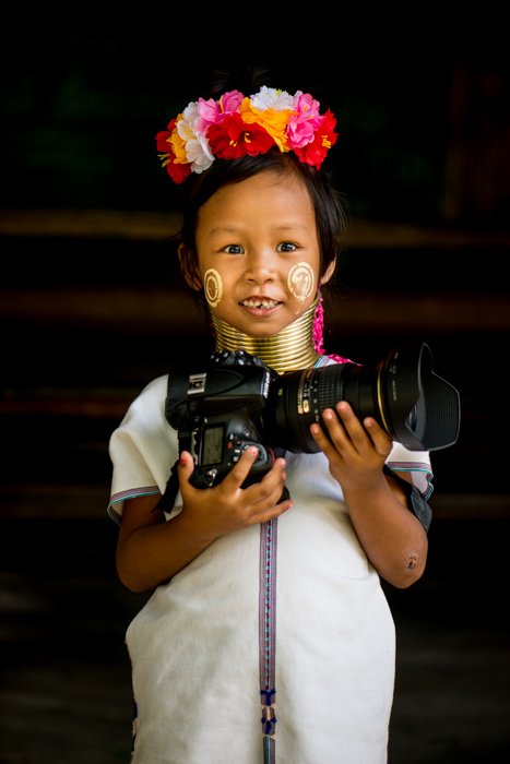 A young karen girl holding a large DSLR camera