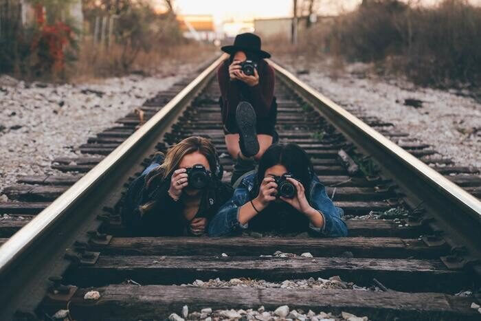 Photo of photographers on railroad tracks 