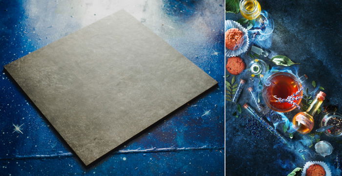 left: grey flat background material on blue background. right: tea, herbs, leaves and a stoppered vial on a dark blue background. 