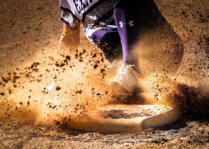 Action photo of a sports person sliding in the dirt