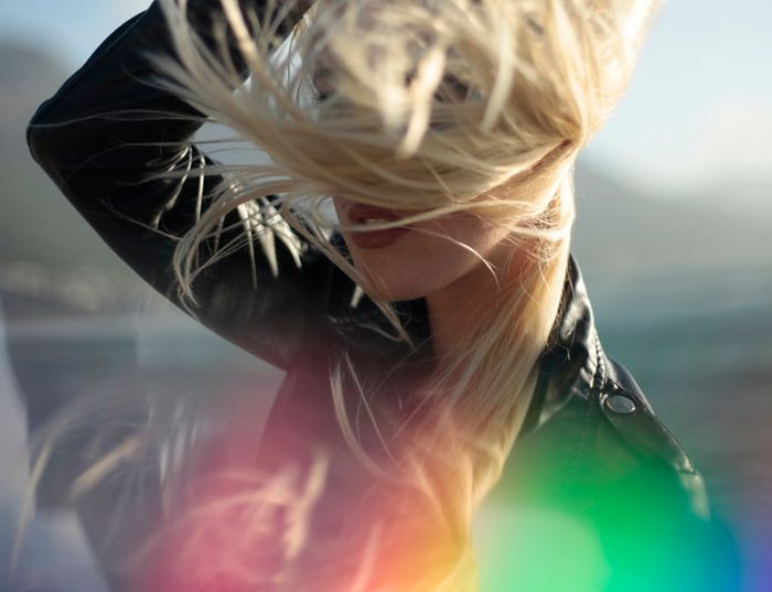 Portrait of a bonde woman with rainbow prism photography effect