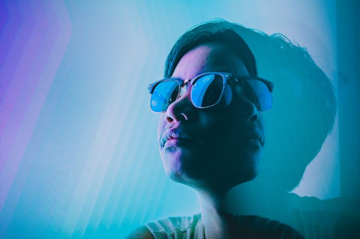 A headshot portrait of a person wearing sunglasses with several exposures for creative lighting photogarphy