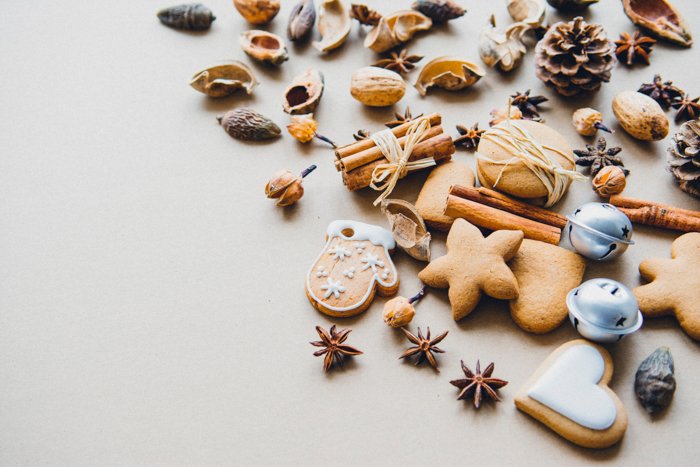christmas themed flatlay with bells, acorns, and cookies