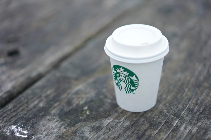 starbucks cup on a grey wood surface