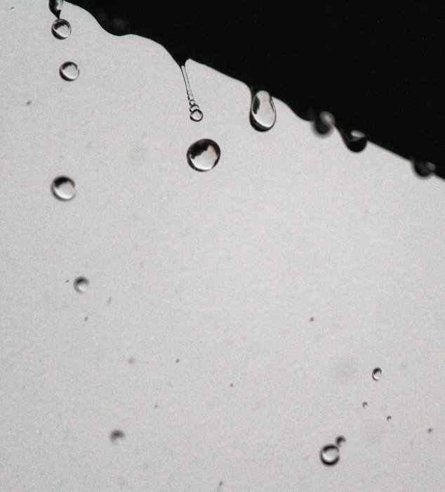 Minimal close up photo of raindrops falling shot with fast shutter speed