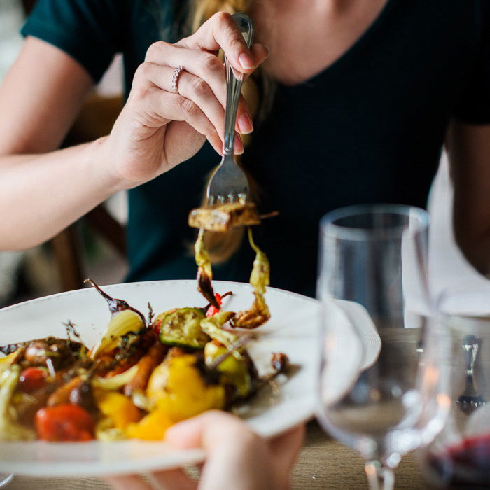 A close up smartphone food photography shot of people sharing a scrumptious looking brunch at a table