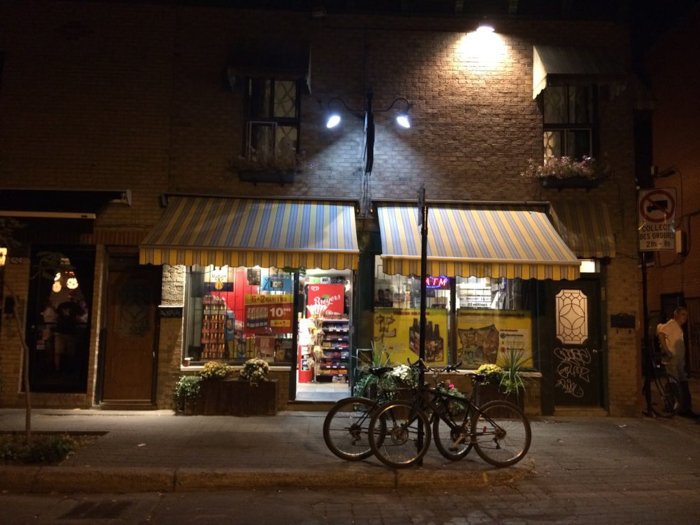 two bicycles parked outside a store under a streetlight