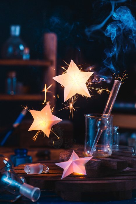 Stars and test tubes in a dark room lit with sparkler photography