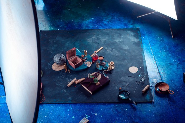 angled view of background board, wood box and other items in flatlay being prepared for a sparkler photography shot