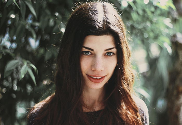 An outdoor portrait of a brunette woman