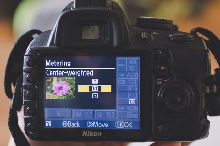 The screen of a Nikon camera showing center-weighted metering settings to learn DSLR basics