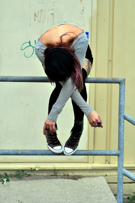 Creative fashion photography shoot featuring a female model posing creatively on a railing