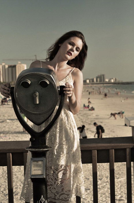 A dreamy fashion photography shot of a female model posing outdoors