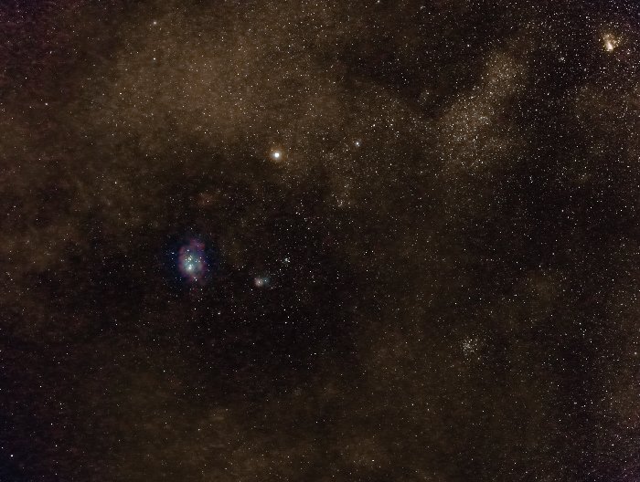 Lagoon and Trifid Nebulae in conjunction with Saturn (above them). On the top-right corner another nebula, the Omega Nebula. 