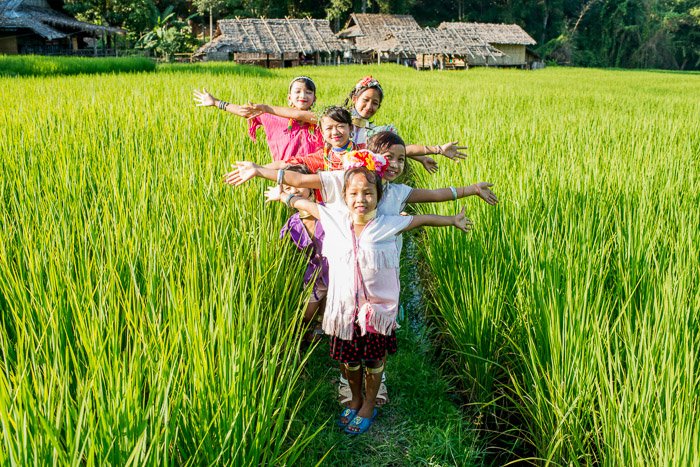 Natural Light Photography shot of a group of kids posing in a rice paddy field - best time to take photos outdoors