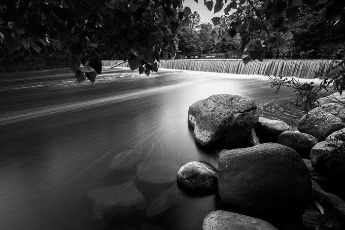 A black and white long exposure photo of Woodland creek in Catskills, New York. 
