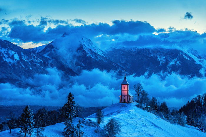 A church lit up in the mountains 