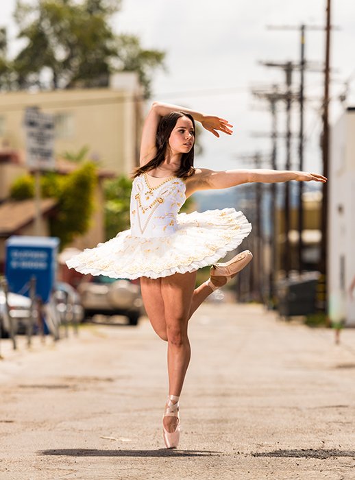 a bright and airy portrait of a ballerina dancing outdoors, poses for good profile pictures