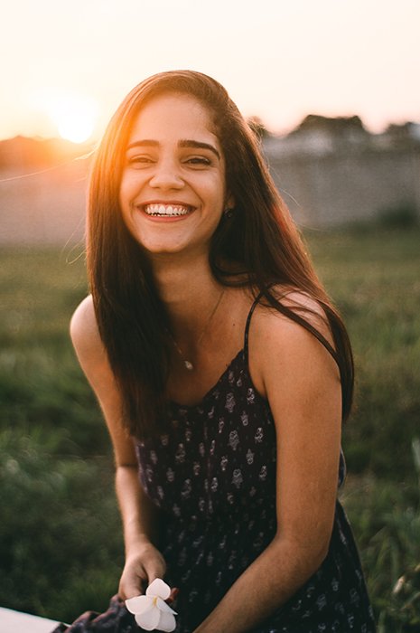 An outdoor portrait of a smiling brunette woman for a cool profile picture
