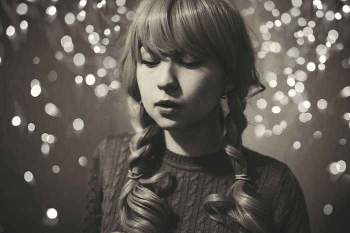 Artistic black and white portrait of a female model posing against a diy backdrop