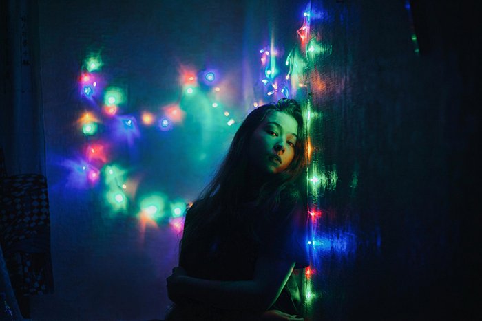 A portrait lit by fairy lights