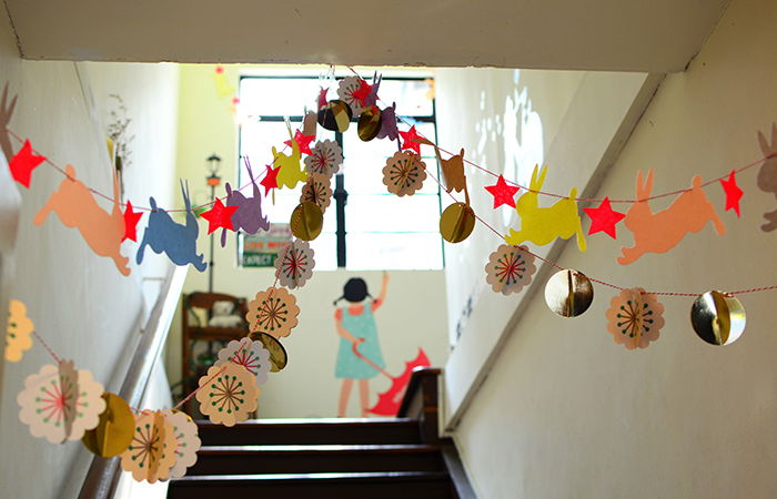 Streams of colored paper chains hanging from a wall