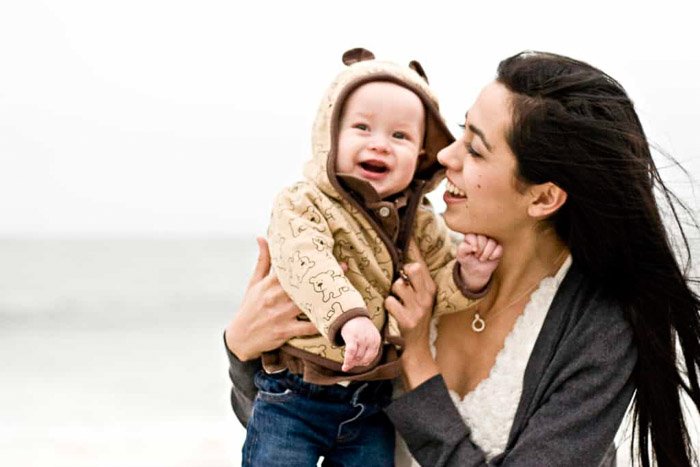 A sweet beach family photo shoot of a mother and baby