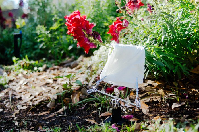 Shot of a white towel set up among flowers and plants for improved flower photography