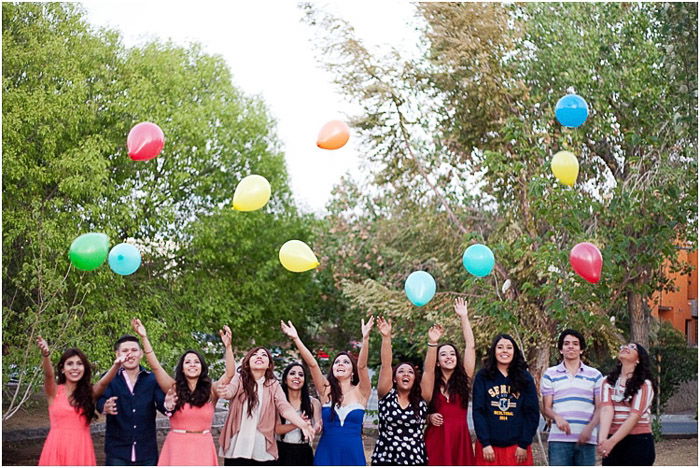 A group of seniors throwing balloons in the air