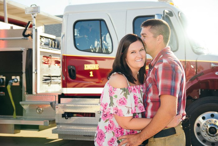 A couple embracing outside a truck in a natural relaxed pose