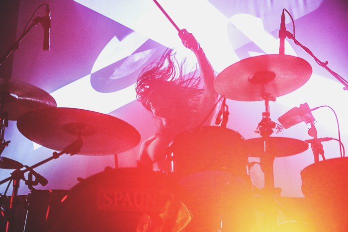 A concert photography shot of a drummer with distorted colors 