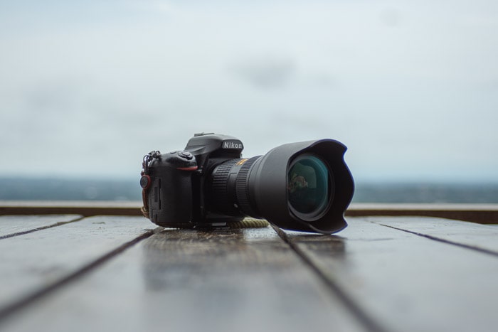 A DSLR camera resting on a table outdoors - camera trade in