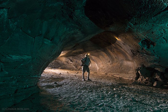 An adventure photographer cave Exploring, Central Oregon