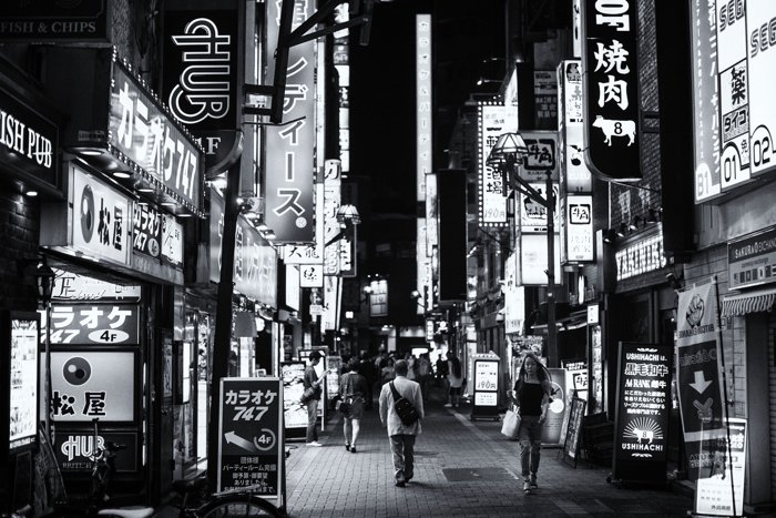 A black and white photo of a busy street scene in Tokyo