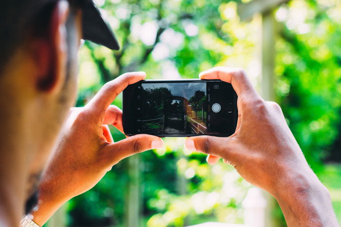 A person taking a time lapse photo with a smartphone 