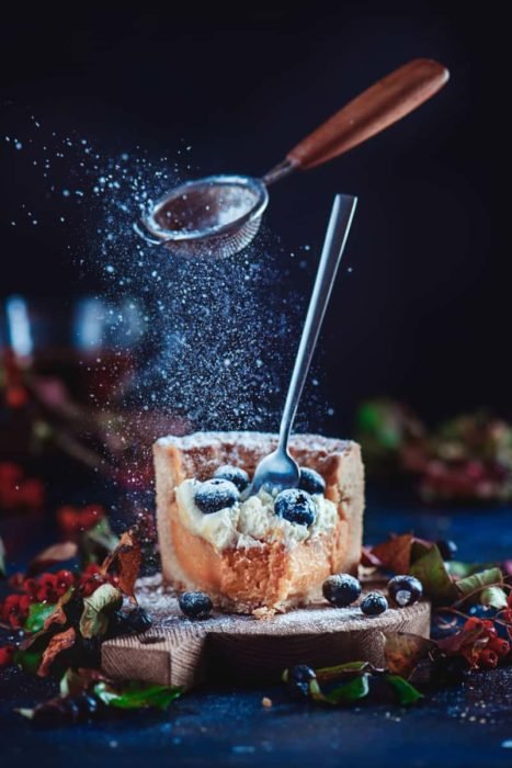 Cool Christmas photos still life of sugar and sieve levitating over a slice of cake