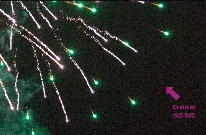 Close up of green fireworks with an arrow pointing out grain