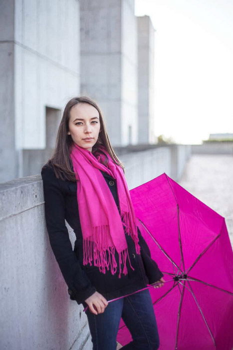 A TFP shoot featuring a female model posing in pink scarf with pink umbrella