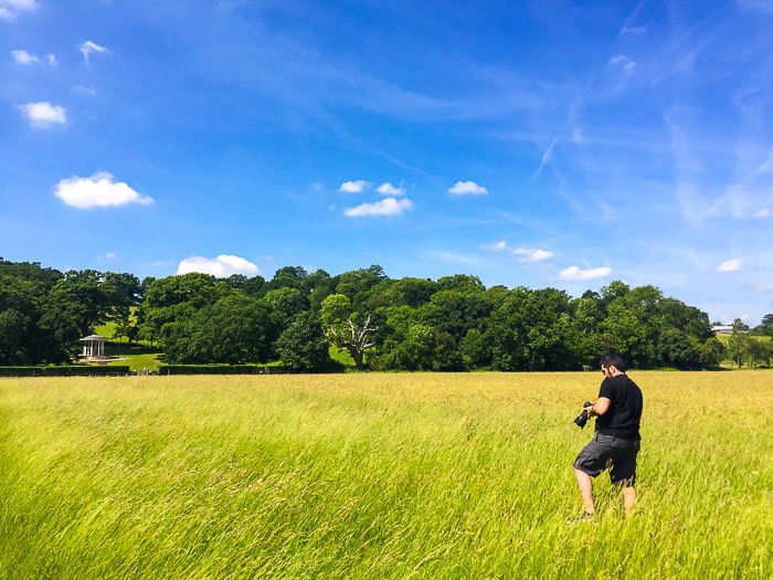 A photographer shooting stock photos in a stunning countryside landscape
