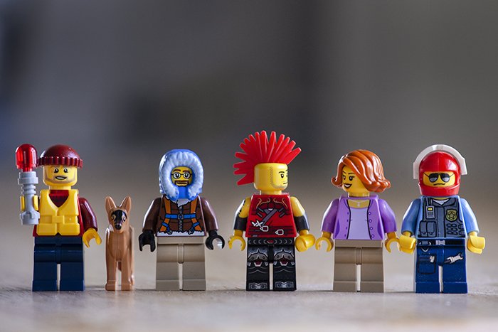A portrait of 6 different lego figures in a line
